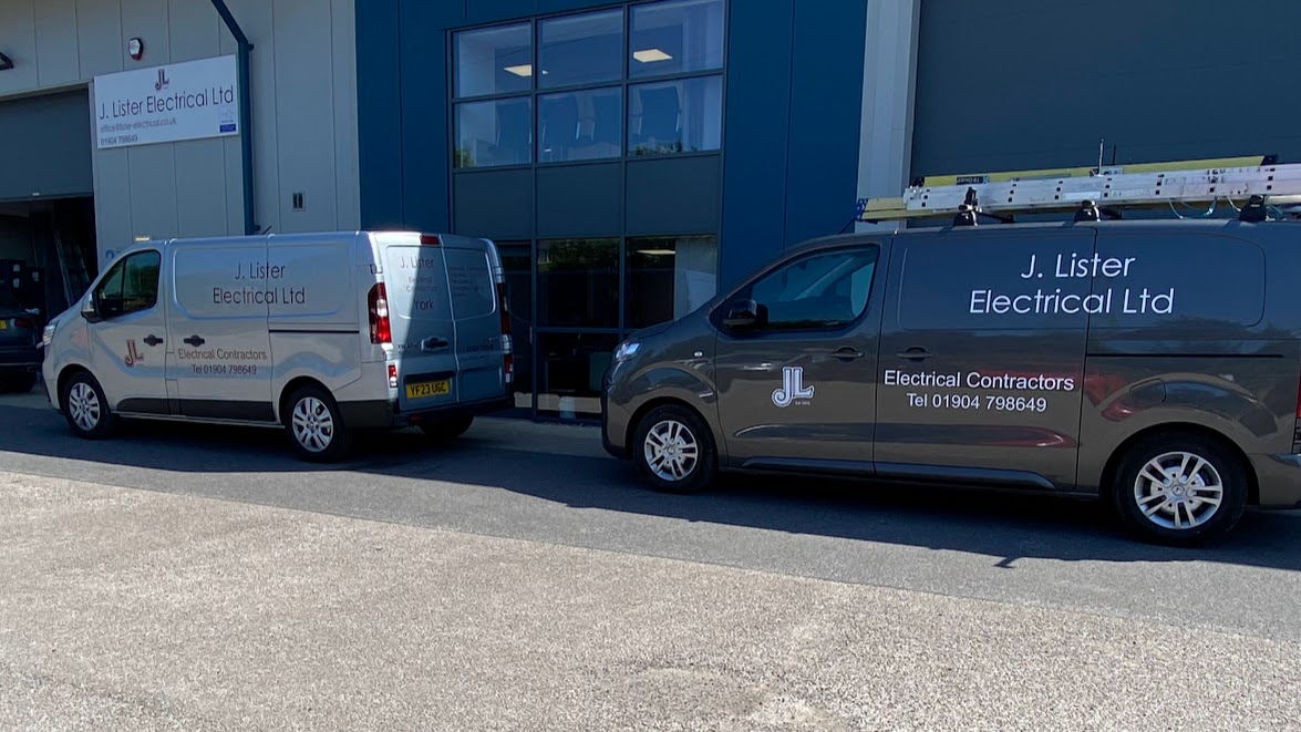 Image of a silver Renault Traffic and a Vauxall Vivaro with branded vehicle graphics